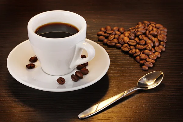 Taza de café sobre mesa de madera sobre fondo marrón — Foto de Stock