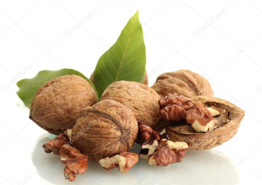 walnuts with green leaves, isolated on white