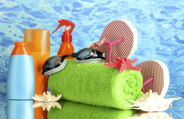 Bright beach accessories, on blue sea background — Stock Photo, Image