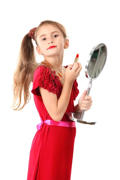 Little girl in her mother's dress, is trying painting her lips, isolated on — Stock Photo, Image