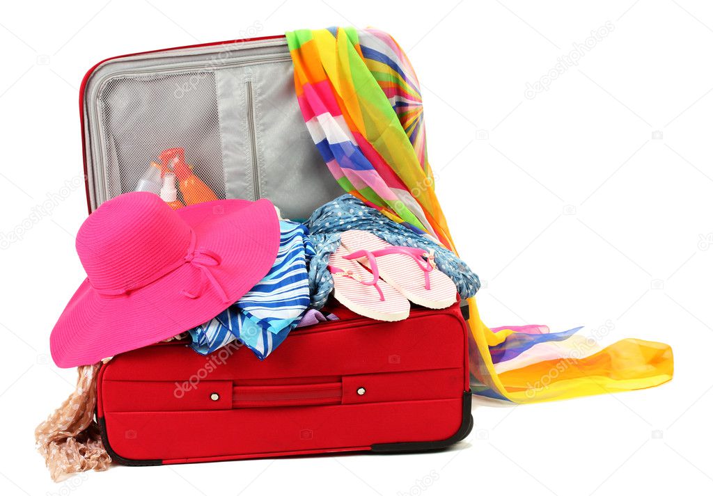 Suitcase with summer clothes, a hat and suntan isolated on white