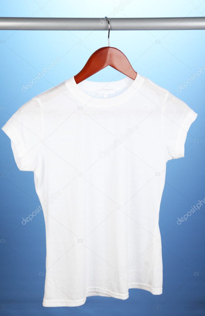White t-shirt on hanger on blue background