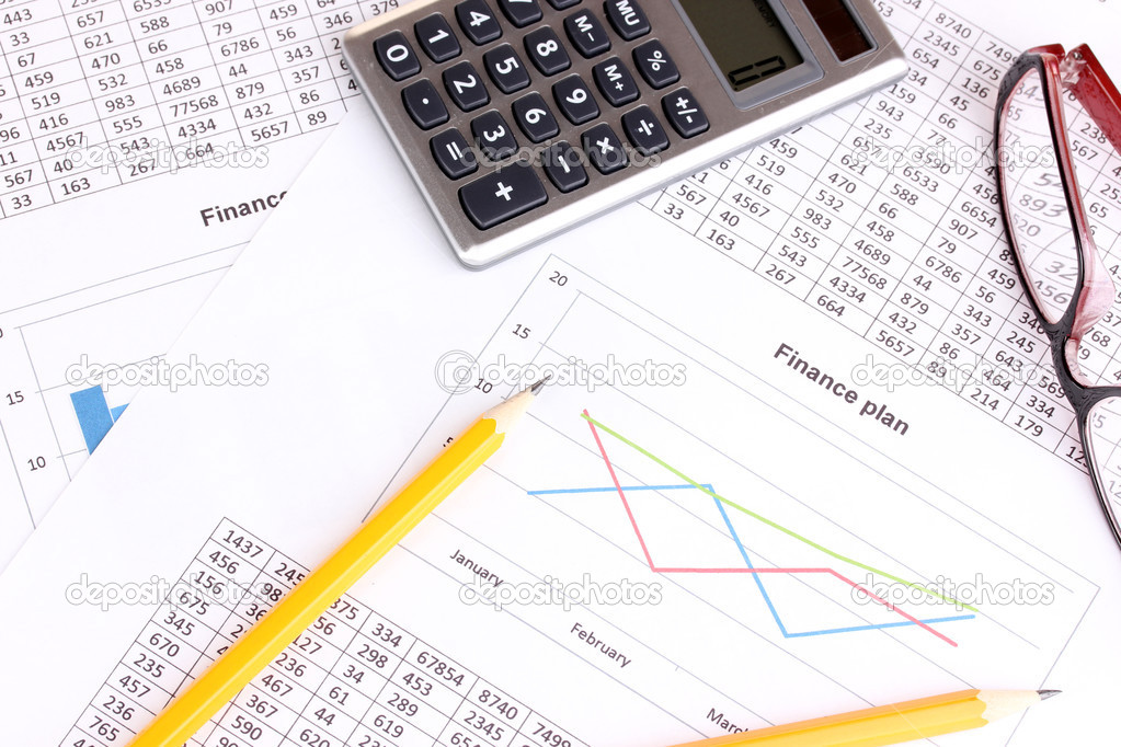 Documents, calculator and glasses close-up