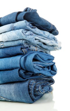 Lot of different blue jeans close-up isolated on white clipart