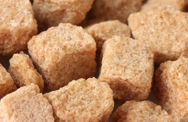 Brown cane sugar cubes background close-up — Stock Photo, Image