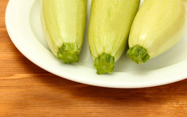 Squash in white plate on wooden table close-up — Stock Photo, Image