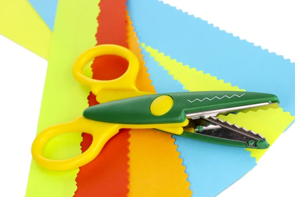 Colorful zigzag scissors with color paper isolated on white — Stock Photo, Image