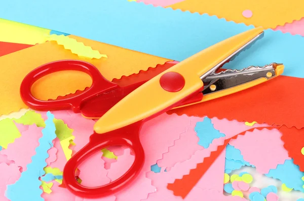 Colorful zigzag scissors on color paper background — Stock Photo, Image