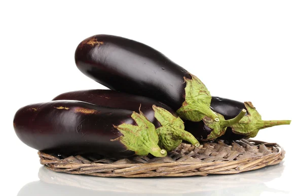 Fresh eggplants on wicker mat isolated on white — Stock Photo, Image