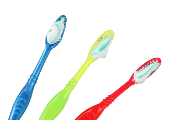 Cepillos de dientes en vidrio aislado en blanco — Foto de Stock