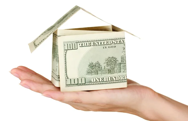 Hand holding a house made of dollars on white background close-up — Stock Photo, Image