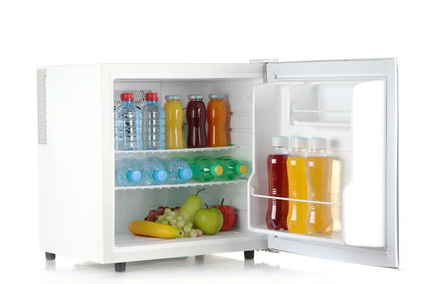 Mini fridge full of bottles of juice, soda and fruit isolated on white — Stock Photo, Image