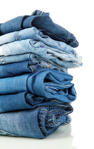 Много различных синих джинсов крупным планом изолированы на белом
