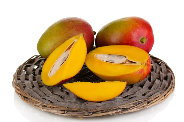 Ripe appetizing mango on wicker cradle isolated on white — Stock Photo, Image