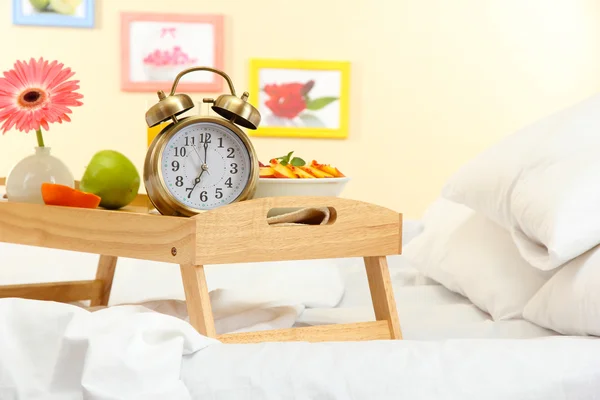 Wooden tray with light breakfast on bed — Stock Photo, Image