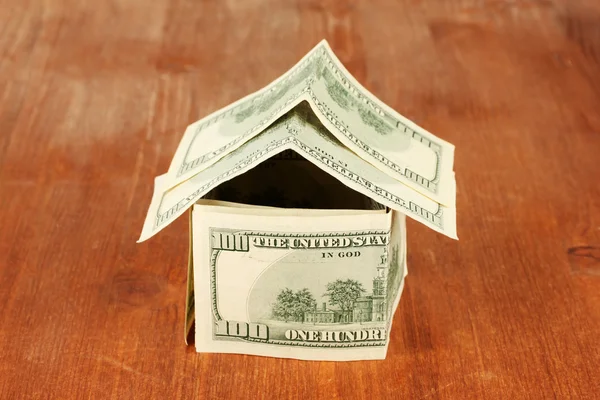 Dollar house on wooden background close-up — Stock Photo, Image