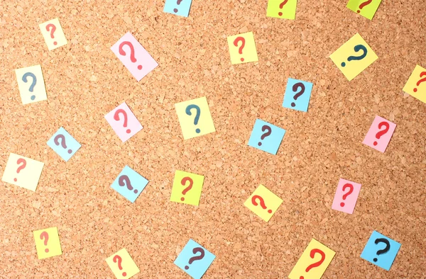 Many question marks on cork board — Stock Photo, Image