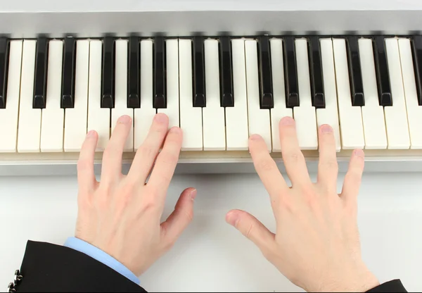 Hands of man playing piano — Stock Photo, Image