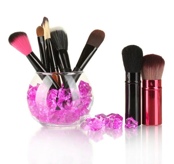 Make-up brushes in a bowl with stones isolated on white — Stock Photo, Image