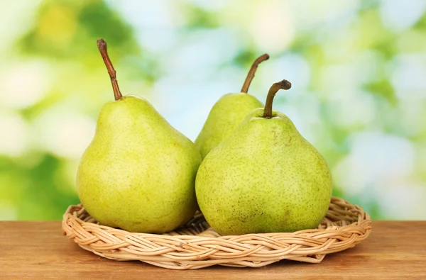 Ripe pears on colorful green background — Stock Photo, Image