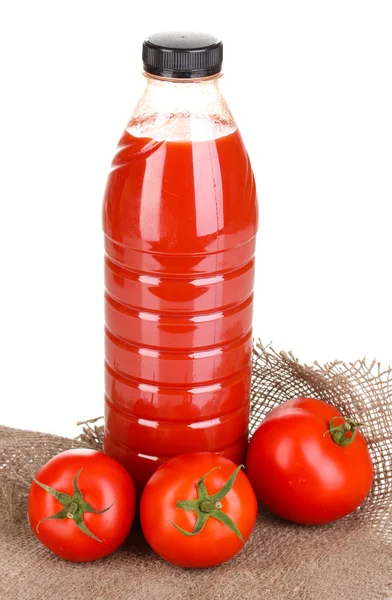 Tomato juice in bottle on sackcloth isolated on white — Stock Photo, Image