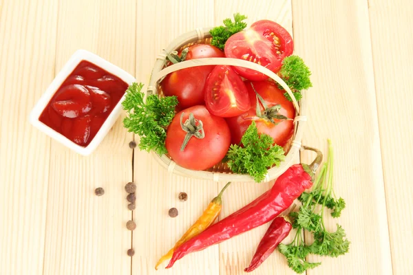 Still life tomatoes ketchup and herbs on wooden table — Stock Photo, Image