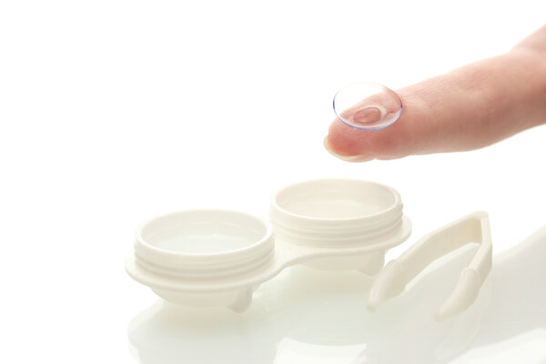 contact lenses in containers and tweezers, isolted on white