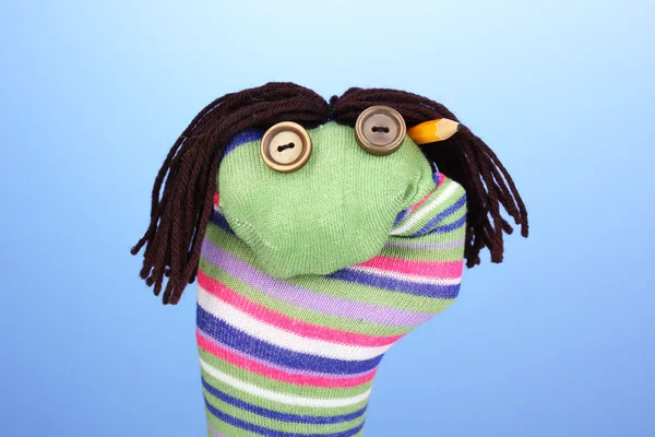 Cute sock puppet on blue background — Stock Photo, Image