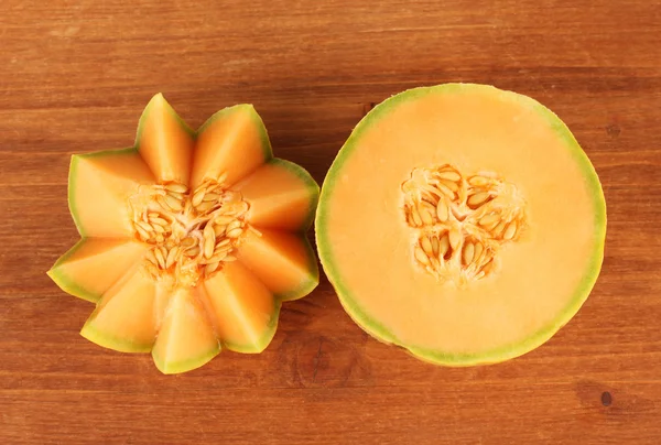 Cut melon on wooden background close-up — Stock Photo, Image