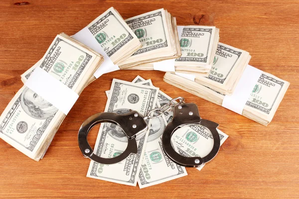 Idea of punishment for financial fraud, on wooden background — Stock Photo, Image