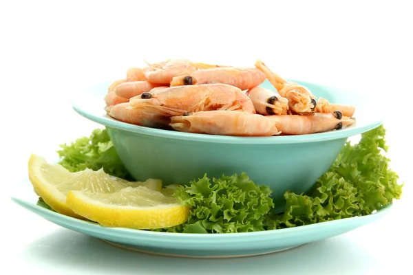 Boiled shrimpsin bowl and lettuce leaves with lemon on plate, isolated on w — Stock Photo, Image