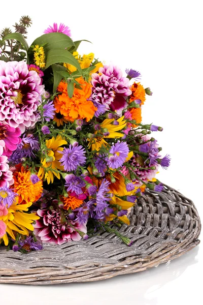 Beautiful bouquet of bright flowers on wicker mat isolated on white — Stock Photo, Image