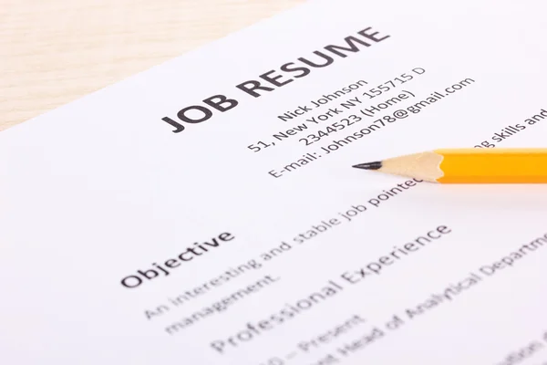 Closeup of resume with pencil on wooden table — Stock Photo, Image