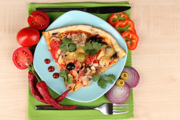 Delicious slice of pizza on color plate with ingredients around close-up on Stock Picture