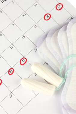 menstruation calendar with sanitary pads and tampons, close-up clipart