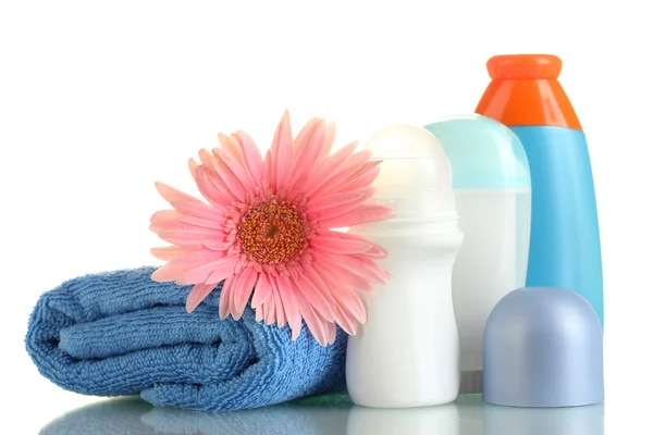 Cosmetics bottles with towel and flower isolated on white — Stock Photo, Image