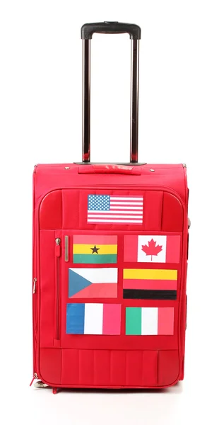 Red suitcase with many stickers with flags of different countriesisolated on white — Stock Photo, Image