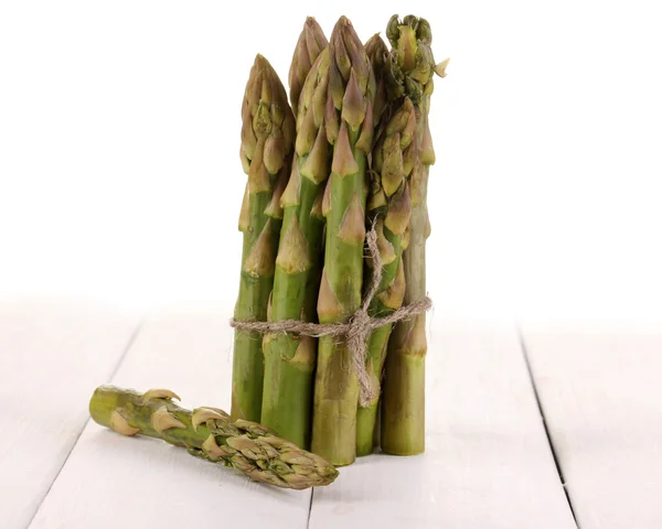 Useful asparagus on wooden table on white background — Stock Photo, Image