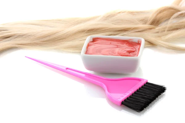 Bowl with hair dye and pink brush on white background close-up Stock Photo