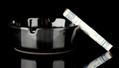 Sigara 100 dolarlık banknot ve siyah izole bir kül tablası