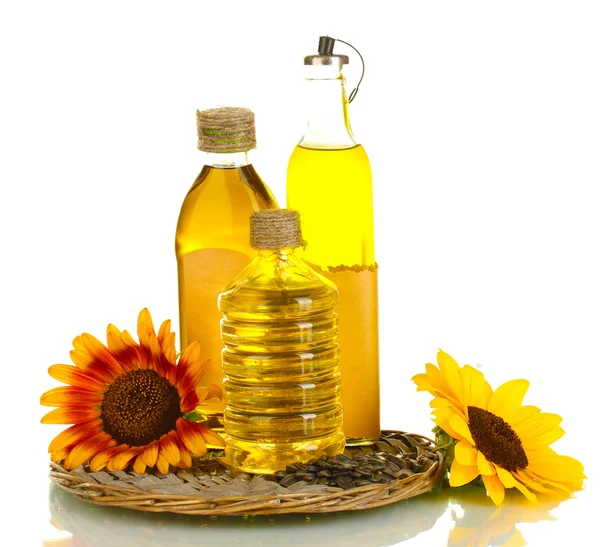 Olie in flessen, zonnebloemen en zaden geïsoleerd op wit — Stockfoto