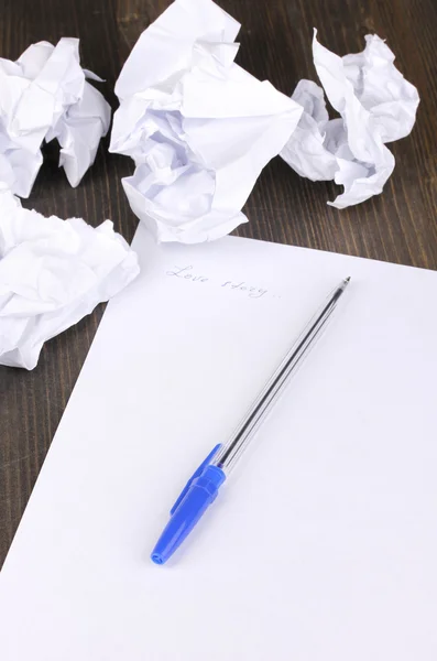 Creation of composition and crumpled sheets on wooden table — Stock Photo, Image