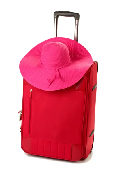 Red suitcase with woman's hat isolated on white — Stock Photo, Image