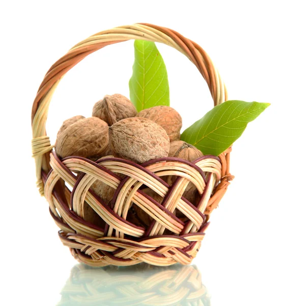 Walnuts with green leaves in basket, isolated on white — Stock Photo, Image