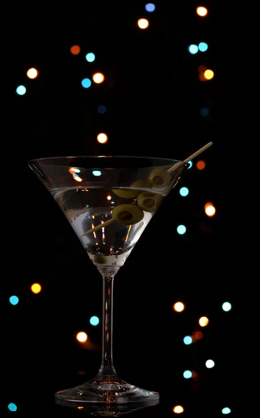 Martini glass and olives on dark bright background — Stock Photo, Image