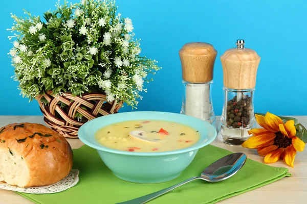 Sopa fragante en plato azul en la mesa sobre fondo azul de cerca — Foto de Stock