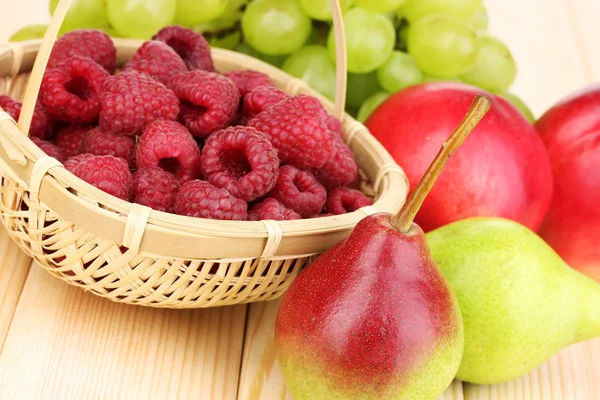 Ripe sweet fruits and berries on wooden background — Stock Photo, Image