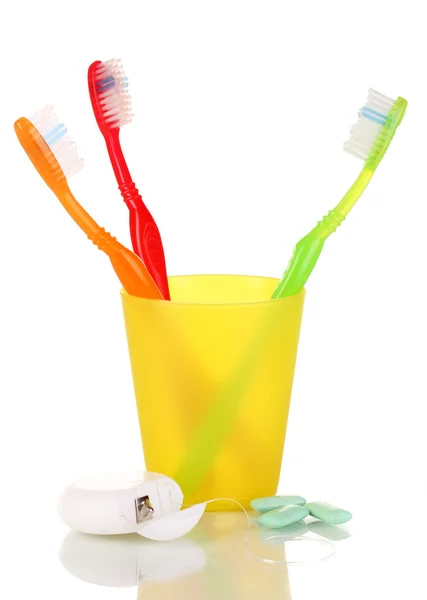 Toothbrushes, chewing gum and dental floss isolated on white — Stock Photo, Image