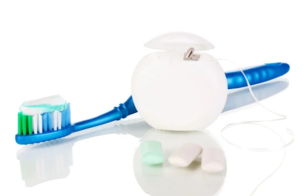 Toothbrush, chewing gum and dental floss isolated on white — Stock Photo, Image