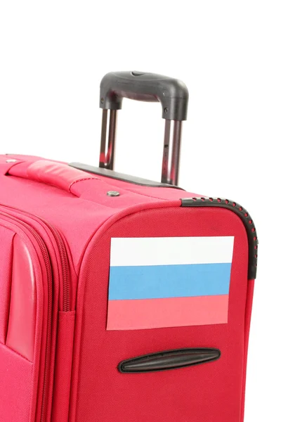 Red suitcase with sticker with flag of Russian Federation isolated on white — Stock Photo, Image